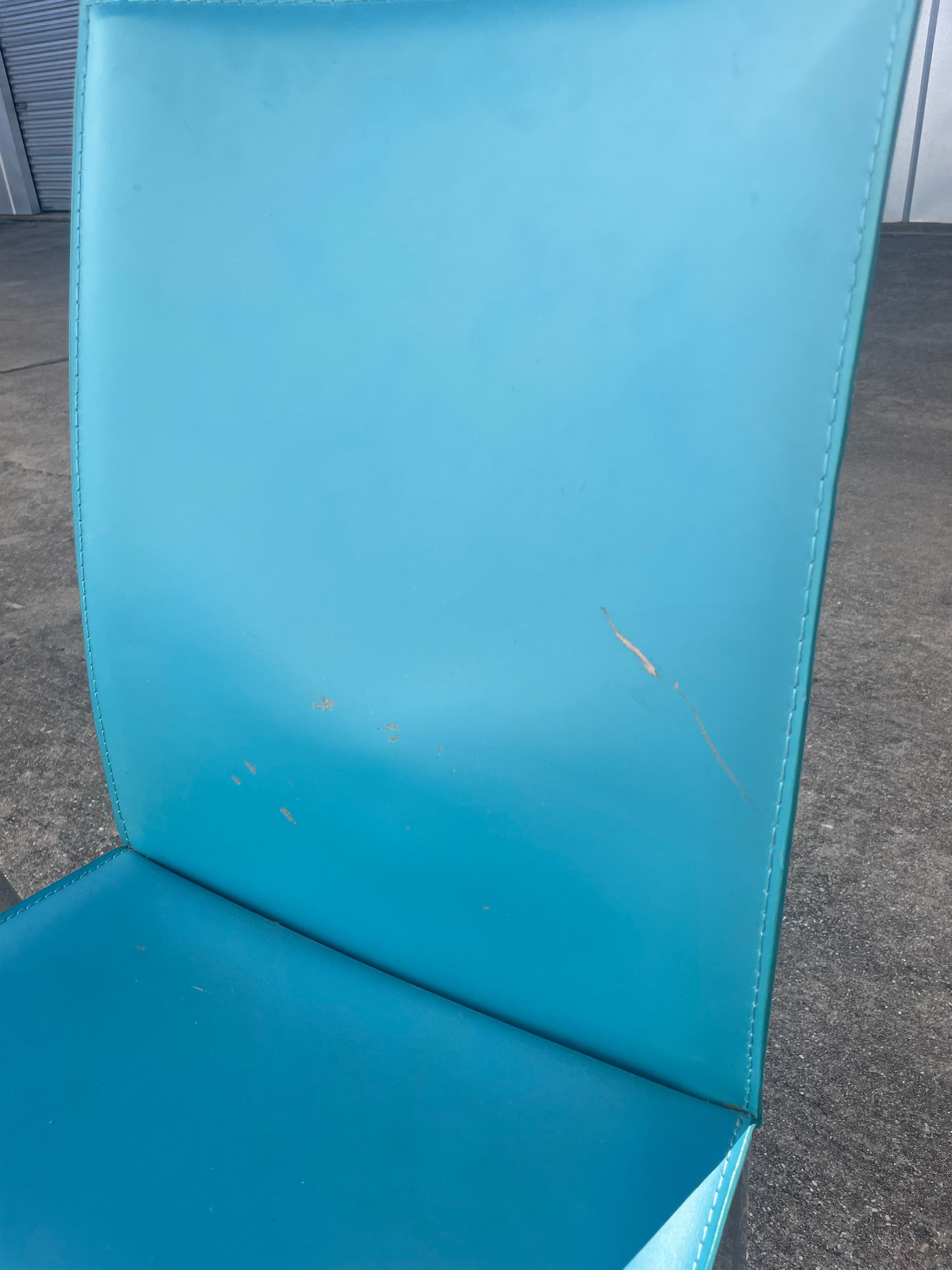 set of four teal leather dining chairs