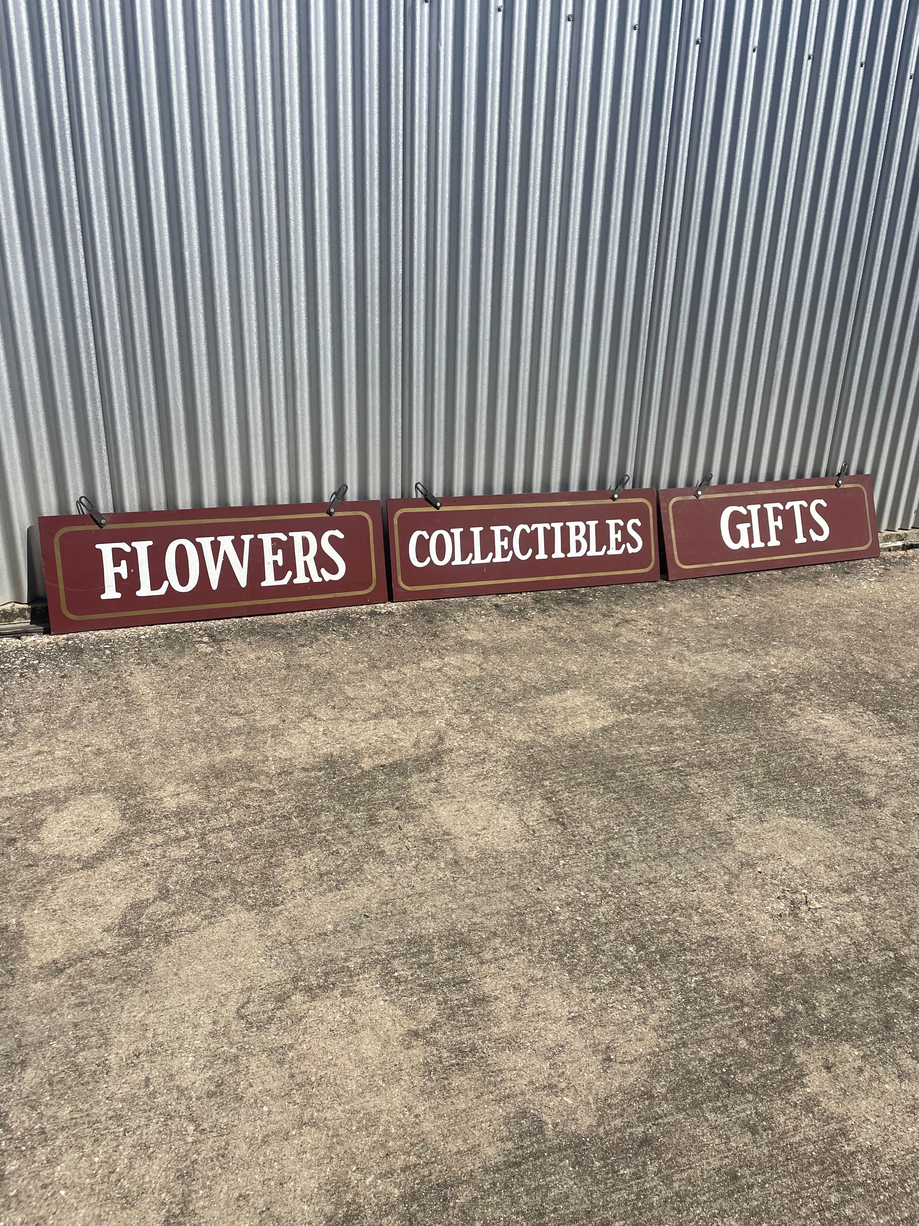 three hand painted signs