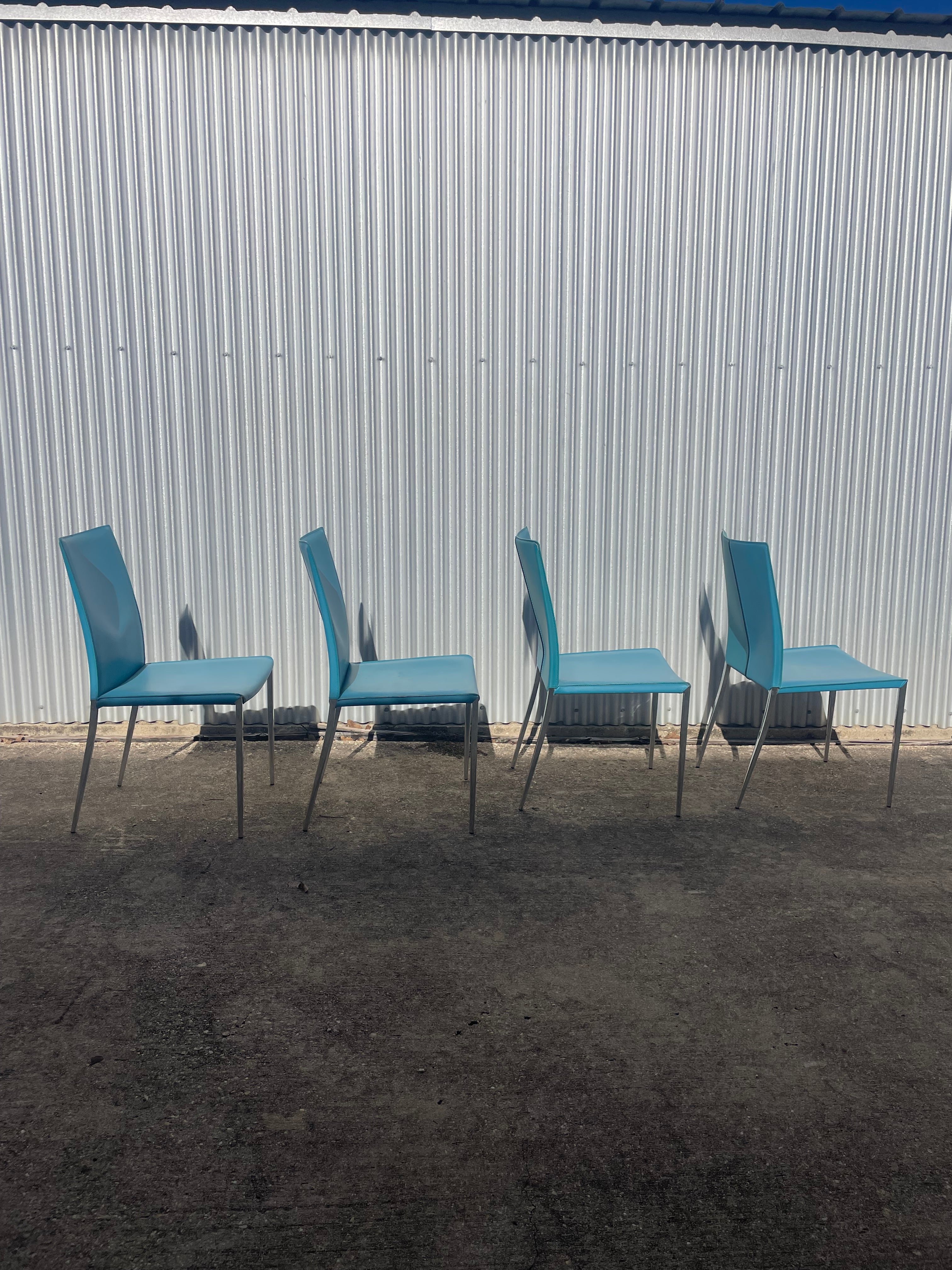 set of four teal leather dining chairs