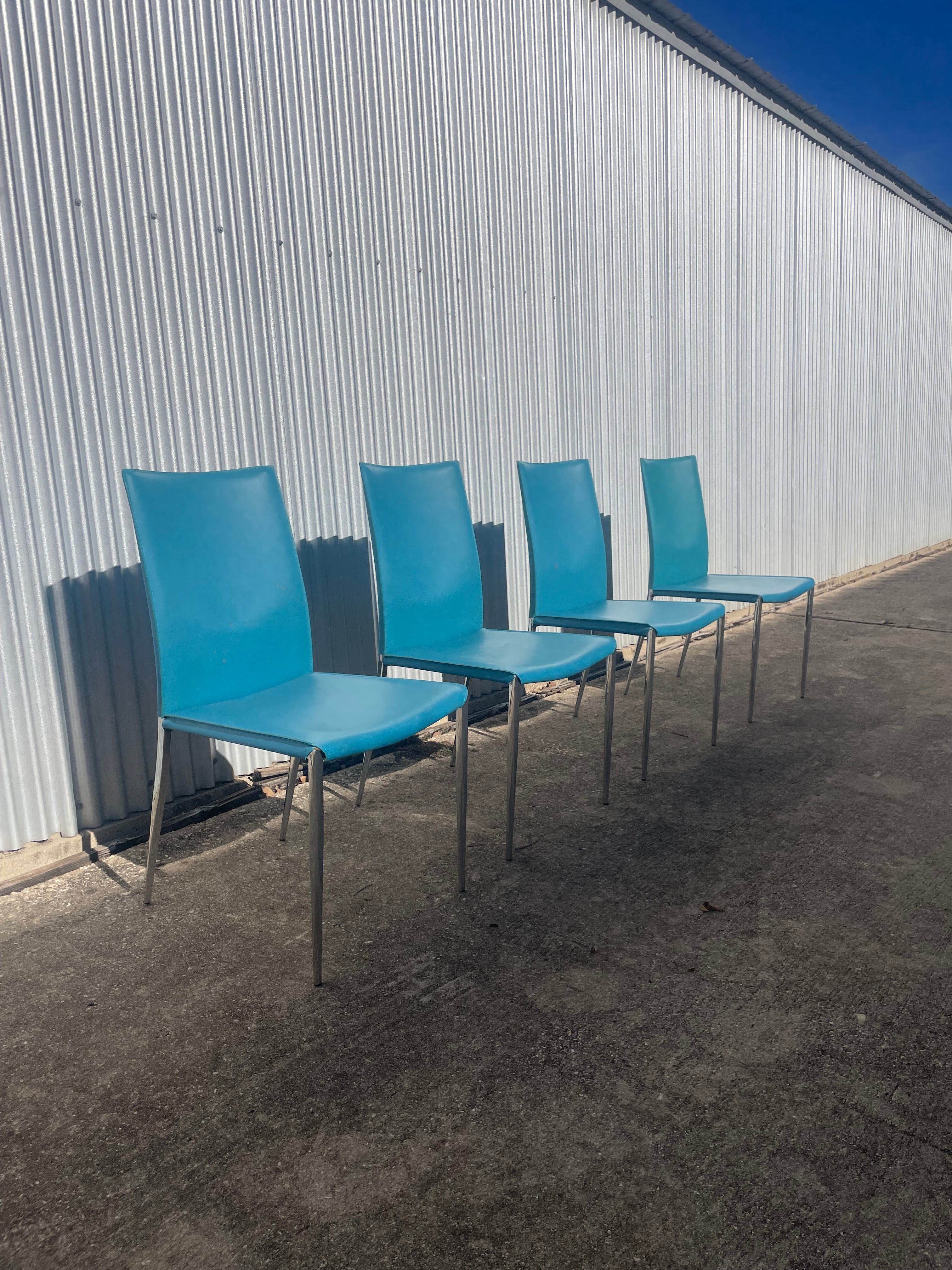 set of four teal leather dining chairs