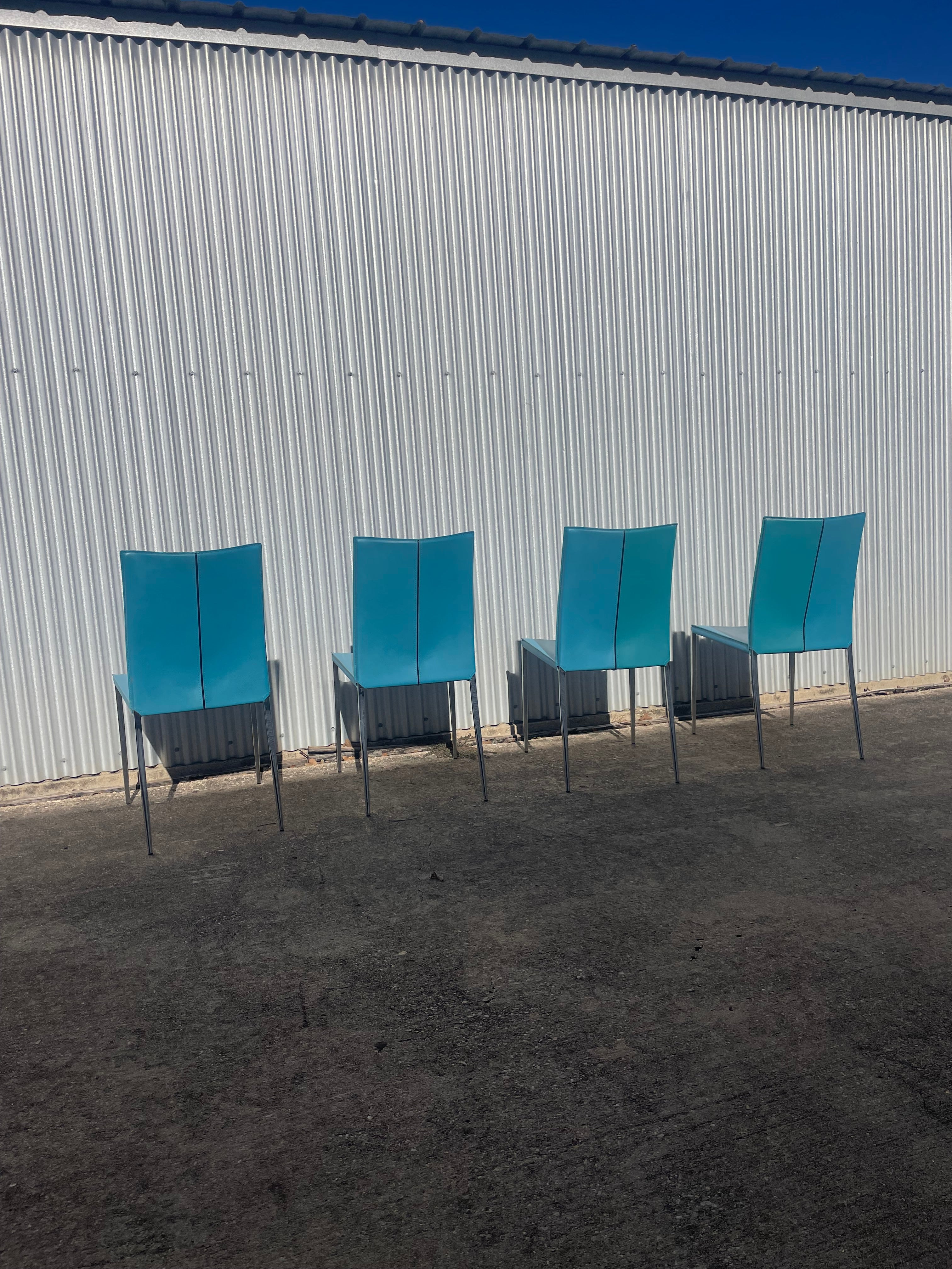set of four teal leather dining chairs