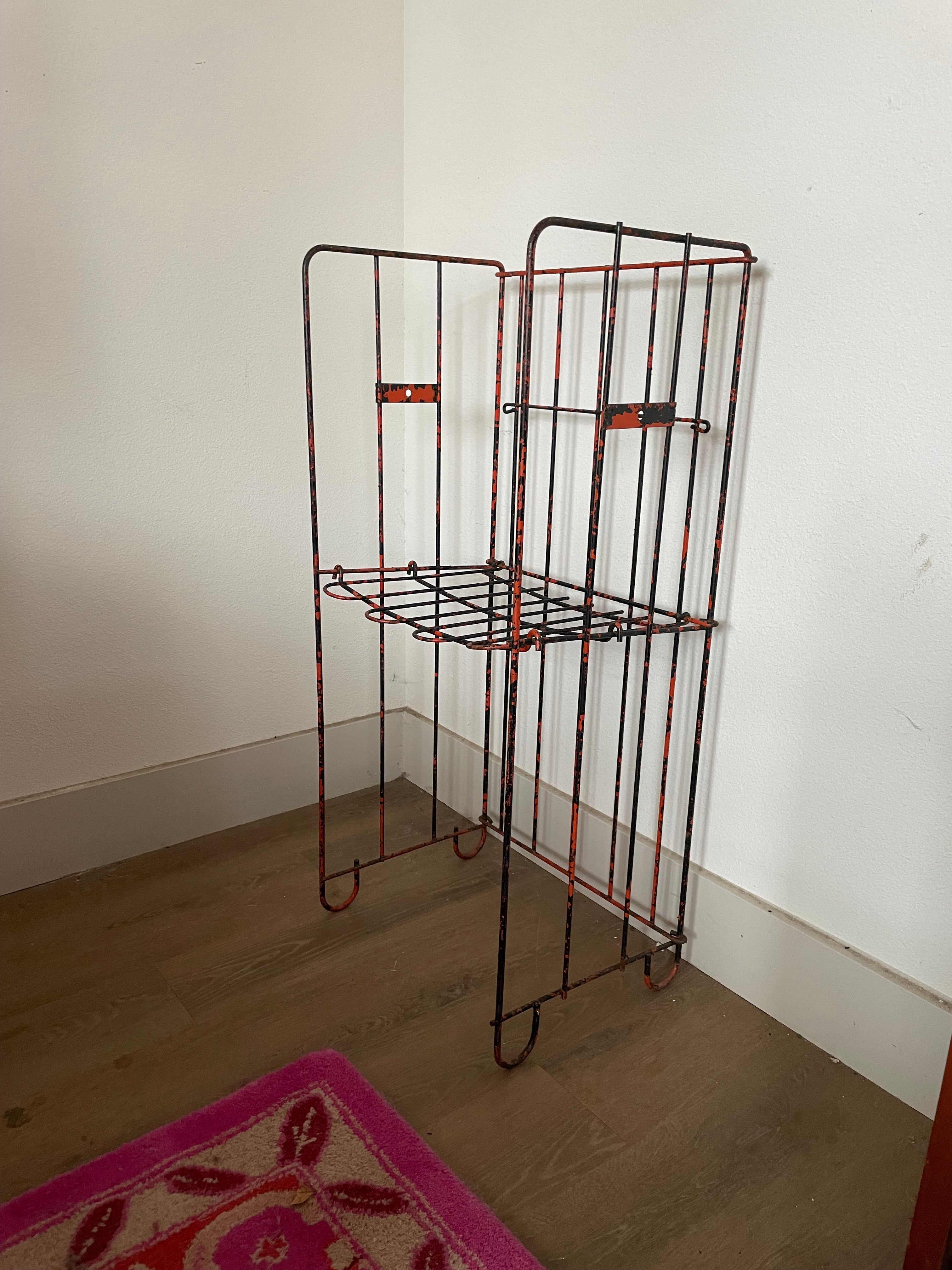 salvage metal magazine rack that is also a chair